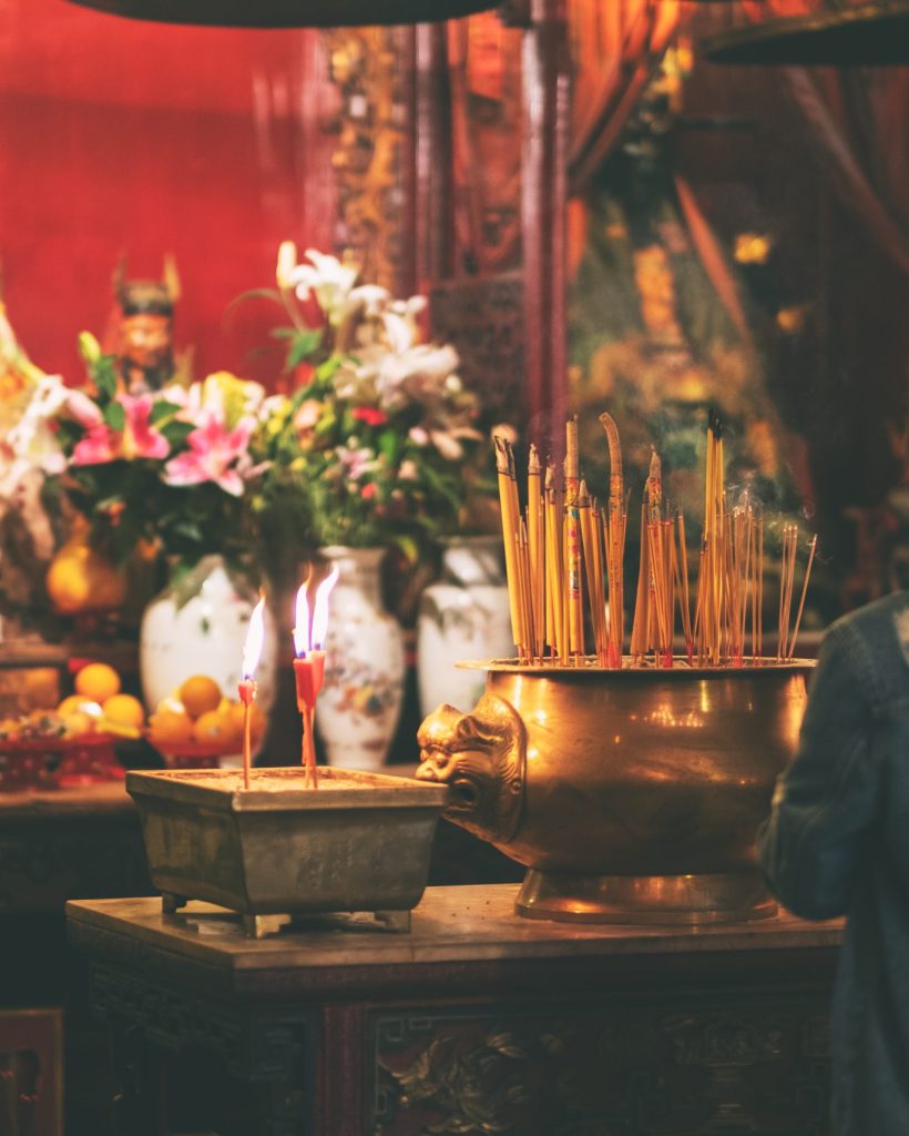 A woman paying respect to buddha image in Chinese temple