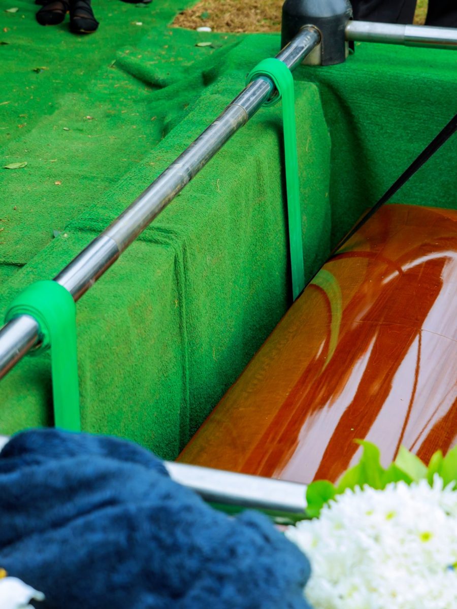 Burying a coffin at a cemetery during a funeral ceremony
