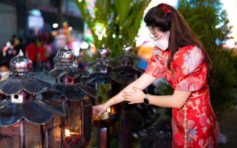 woman-lights-lanterns-at-urban-religious-site-2026-03-17-17-47-45-utc.jpg